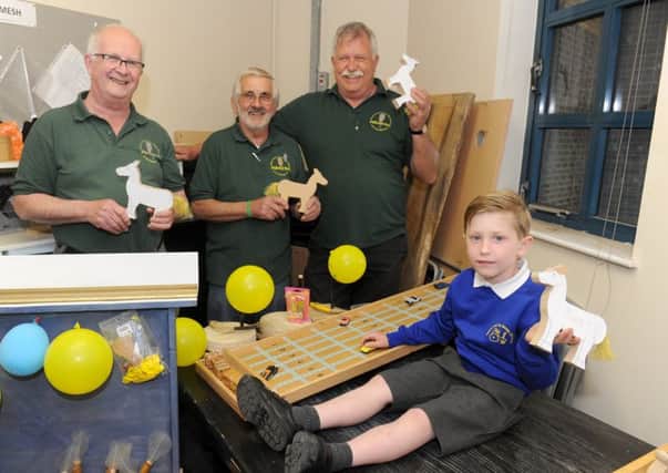 (L-r) Terry Hoy, Frank Rowney and Stewart Burns from Havant Men's Shed with Charles Coe (5) who collected the toys and games on behalf of Compton and Up Marden CofE Primary School.  Picture: Sarah Standing (170591-7228)
