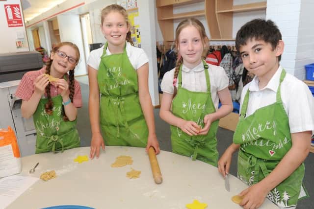 (L-r) Joanna Edgecumbe (9), Jodie Carter (10), Tilly Stone (10) and Dimo Rosenov (9) making ocean animal biscuits. Picture: Sarah Standing (170723-2864)
