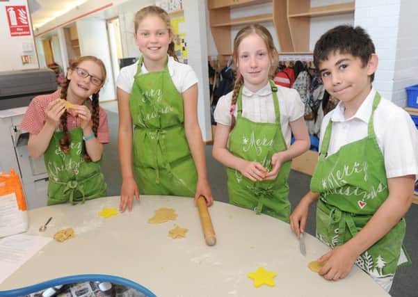 (L-r) Joanna Edgecumbe (9), Jodie Carter (10), Tilly Stone (10) and Dimo Rosenov (9) making ocean animal biscuits.  Picture: Sarah Standing (170723-2864)