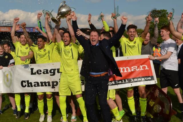 Lee Bradbury and his Hawks celebrate the Ryman League premier division title