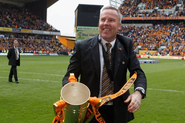 Kenny Jackett celebrates the League One title at Wolves
