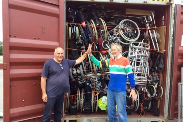 Lloyd Clewer, left, the founder of Farm4Life, with volunteer David Farr in front of the container