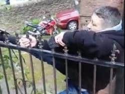 The man was found hanging onto the gate