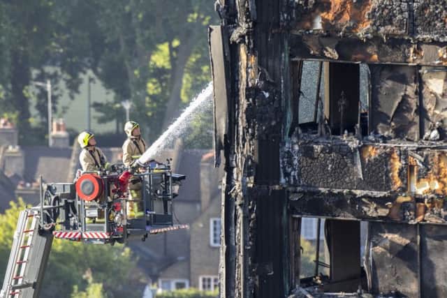 Water is sprayed on Grenfell Tower in west London after a fire engulfed the 24-storey building on Wednesday morning
