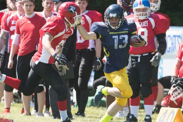 Zac Edwards attempts to fend off a tackle during the Dreadnoughts game with the Berkshire Renegades on Sunday Picture: Keith Woodland