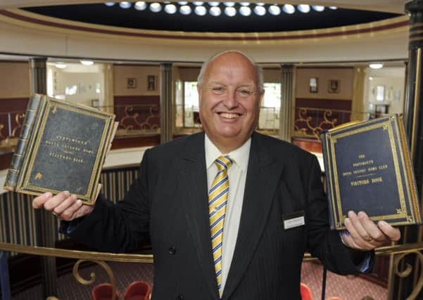 John Alderson general manager at the Royal Maritime Club in Portsmouth with the club's two historical visitors' books. 
Picture: Ian Hargreaves