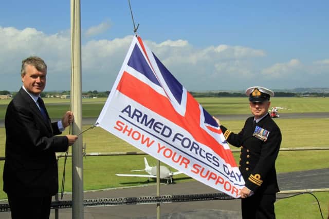 Cllr Sean Woodward and Lieutenant Commander Tug Wilson at Daedalus with the Armed Forces Day flag