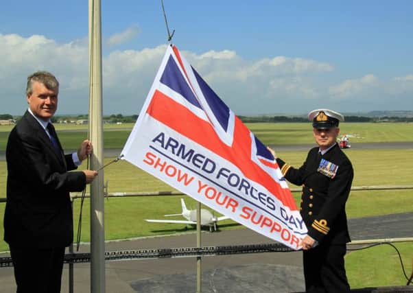 Cllr Sean Woodward and Lieutenant Commander Tug Wilson at Daedalus with the Armed Forces Day flag