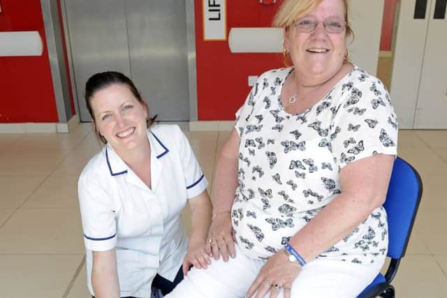 Anna Walker, physiotherapy lead at Queen Alexandra Hospital, gives Sylvia Downs, 62, from Paulsgrove advice on exercises Picture: Malcolm Wells (170619-0657)