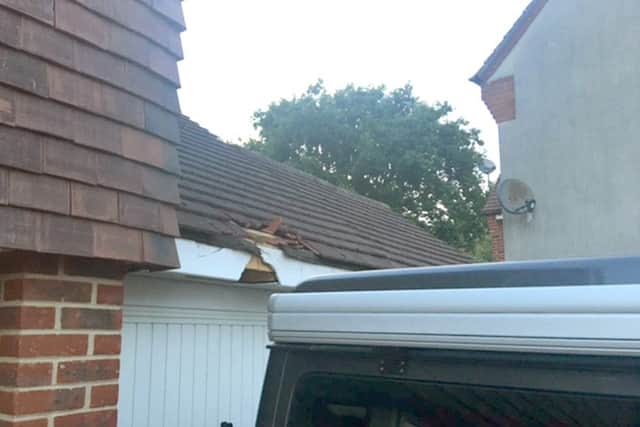 The damaged garage roof, smashed guttering and fascia, thought to have been cause by debris from a plane     Picture: Dan Wells
