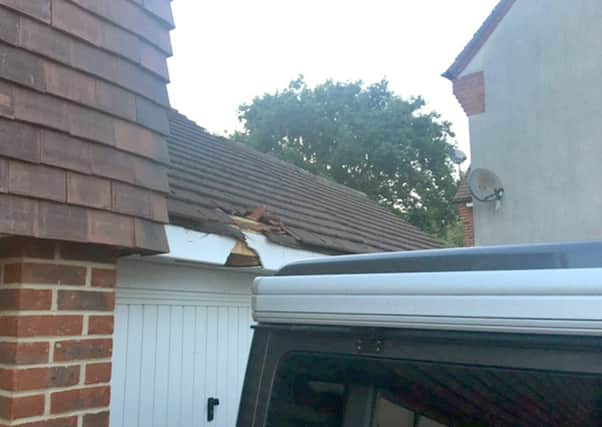 The damaged garage roof, smashed guttering and fascia, thought to have been cause by debris from a plane     Picture: Dan Wells