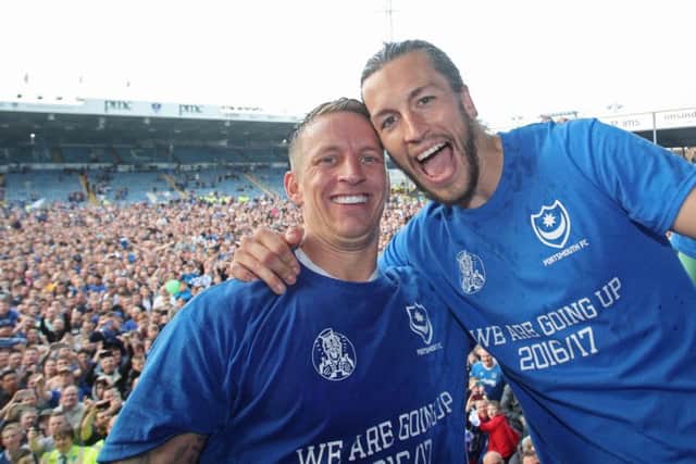 Carl Baker and Christian Burgess celebrate Pompey's League Two title success. Picture:Joe Pepler