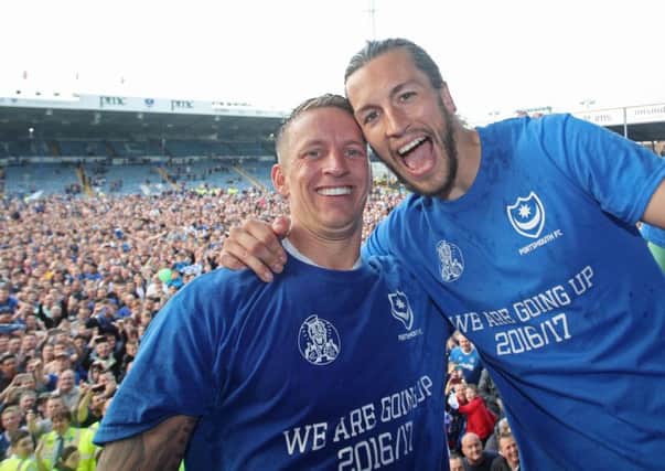 Carl Baker and Christian Burgess celebrate Pompey's League Two title success. Picture:Joe Pepler