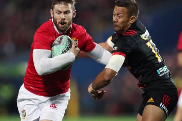 British and Irish Lions' Elliot Daly, left, is tackled by Chiefs' Solomon Alaimalo during the tour match at the FMG Stadium, Hamilton