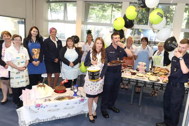 Civilian and military staff tuck into some of the cakes at HMS Sultan, Gosport