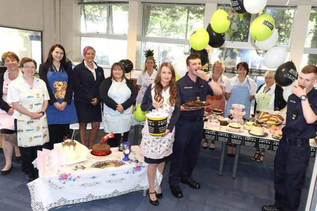 Civilian and military staff tuck into some of the cakes at HMS Sultan, Gosport