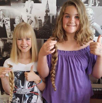 Sisters Willow-Mae Peak, left, and Macey-Rose, after having their hair cut for the Little Princess Trust