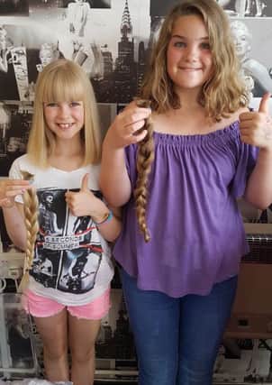Sisters Willow-Mae Peak, left, and Macey-Rose, after having their hair cut for the Little Princess Trust