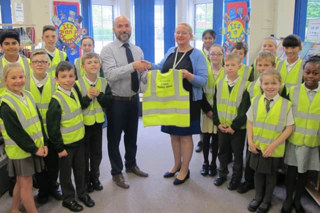 SAFETY FIRST Pupils from Court Lane Junior School and Head of School Sam Cantini, centre right, with Covers Home Ideas depot manager Richard Murrell, centre left