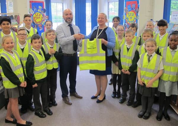 SAFETY FIRST Pupils from Court Lane Junior School and Head of School Sam Cantini, centre right, with Covers Home Ideas depot manager Richard Murrell, centre left