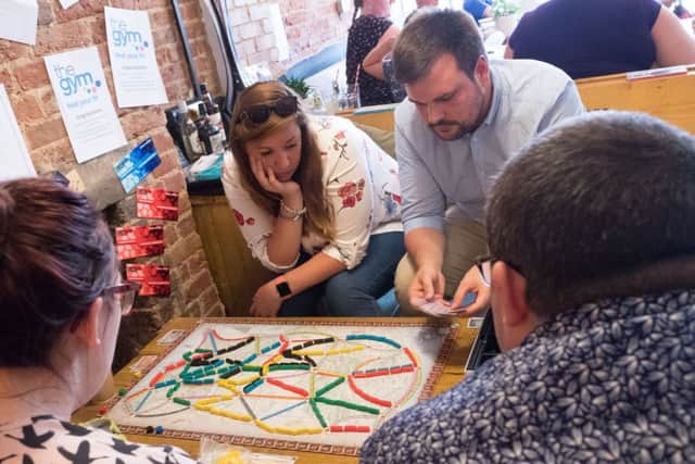 Another group of people enjoying one of the many games on offer. Picture by Keith Woodland (170778)