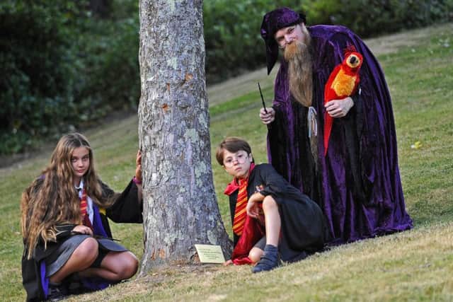 (L-r) 'Hermione Granger' Phoebie Hull, nine, from Gosport, 'Harry Potter' Noah Rawlins-Matus, six, from Locks Heath and 'Albus Dumbledore' Paul Wright, 36, from Swanmore with 'Fawkes' the Phoenix   Picture: Malcolm Wells (170626-1998)