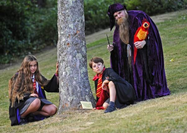 (L-r) 'Hermione Granger' Phoebie Hull, nine, from Gosport, 'Harry Potter' Noah Rawlins-Matus, six, from Locks Heath and 'Albus Dumbledore' Paul Wright, 36, from Swanmore with 'Fawkes' the Phoenix Picture: Malcolm Wells (170626-1998)