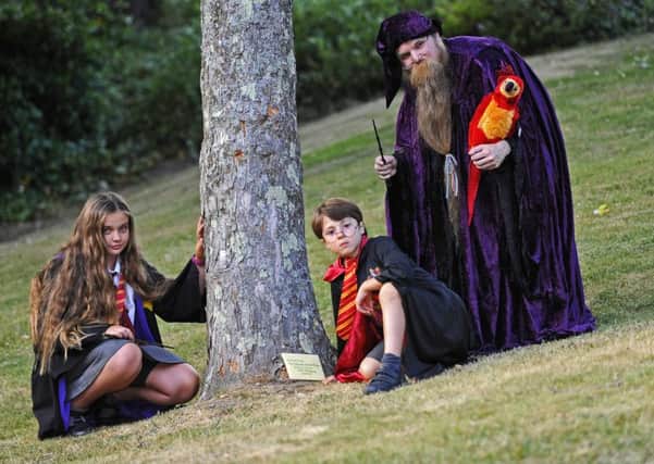 (L-r) 'Hermione Granger' Phoebie Hull, nine, from Gosport, 'Harry Potter' Noah Rawlins-Matus, six, from Locks Heath and 'Albus Dumbledore' Paul Wright, 36, from Swanmore with 'Fawkes' the Phoenix   Picture: Malcolm Wells (170626-1998)