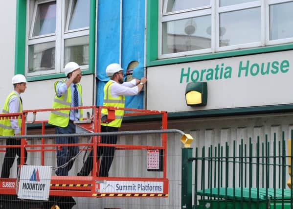 The scene on Friday afternoon, as work begun to remove cladding from Horatia House, Somers Town. 
Picture: Sarah Standing (170831-9641) PPP-170623-182618001