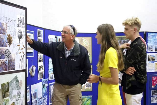 Mr Davis with Oscar Davis and Fiona Brown looking at Fiona's work, both 16
