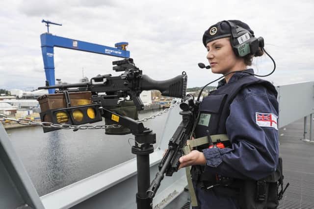 Able Seaman Robyn Wright guards the ship as she sails