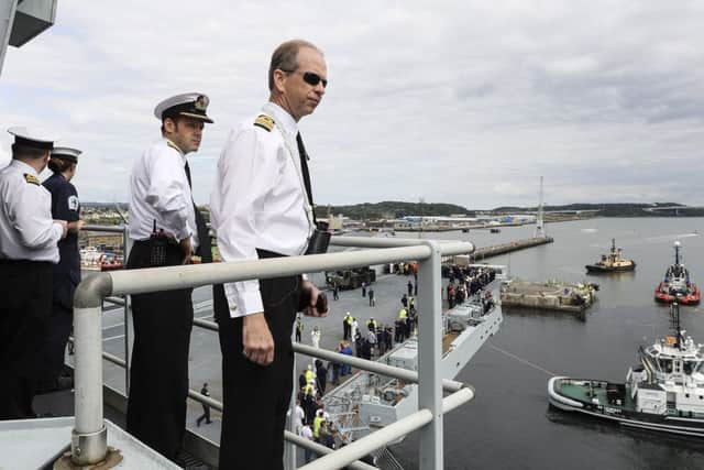 HMS Queen Elizabeth's captain Jerry Kid and the Commander monitoring progress as the ship sails out of the basin