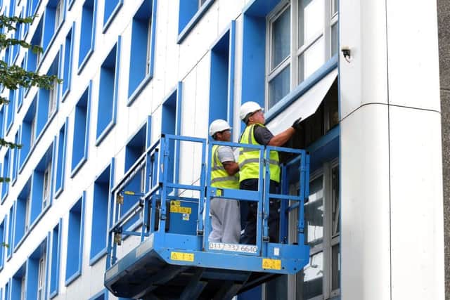 Cladding being removed from Horatia House and Leamington House on Friday evening.
Picture: Sarah Standing