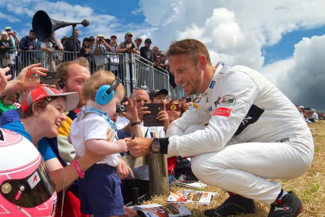 Jenson Button meets a young fan