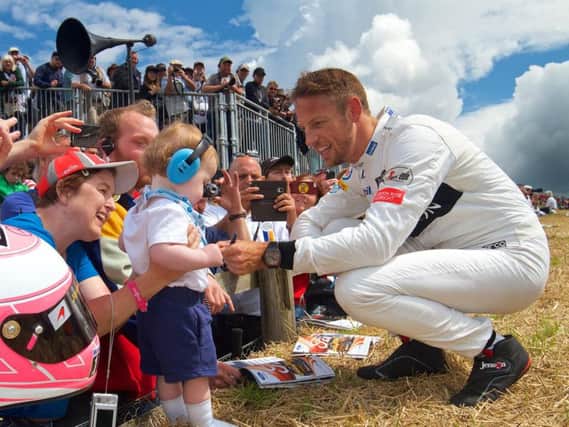 Jenson Button meets a young fan