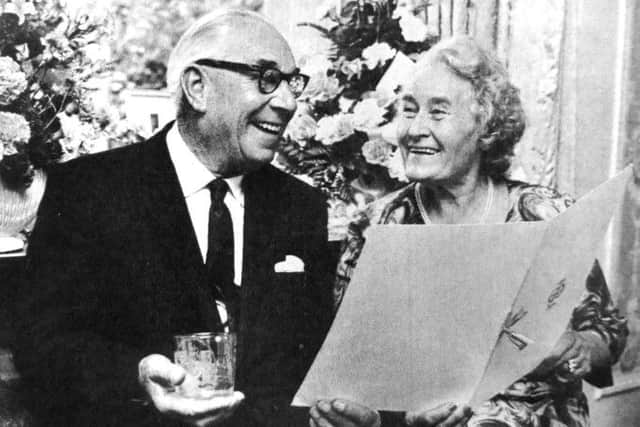 Mr and Mrs Day studying the list of the 40 citizens and friends who subscribed for the 19th century engraved goblet they received for their golden wedding anniversary.
(7602-1)