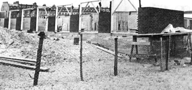 Residents on the Sea Front on Hayling Island complain about the row of beach huts, they have nicknamed the 'Berlin wall', being built along the shore. 
(7546-1)