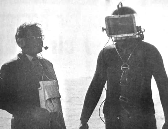 Tony Evans (left) and Maurice Harknett testing the telephone communication system, installed in a free diving outfit.