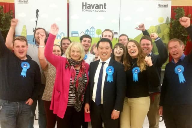 Alan Mak, centre, celebrates with supporters after being re-elected as MP for Havant