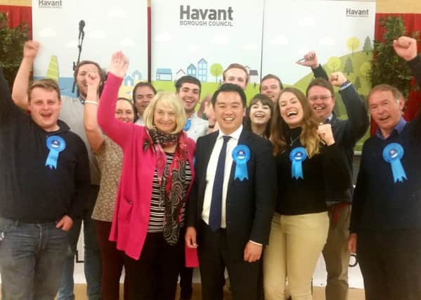 Alan Mak, centre, celebrates with supporters after being re-elected as MP for Havant