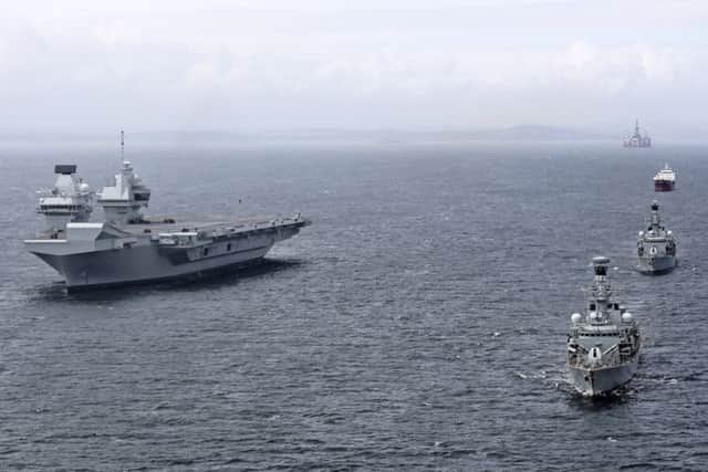 HMS Sutherland and HMS Iron Duke, from Portsmouth, took the opportunity to say hello to the Royal Navy's newest aircraft carrier HMS Queen Elizabeth. HMS Queen Elizabeth was at anchor in Scotland after sailing from HMNB Clyde for the first time only a couple of days ago. PHOTO: Royal Navy