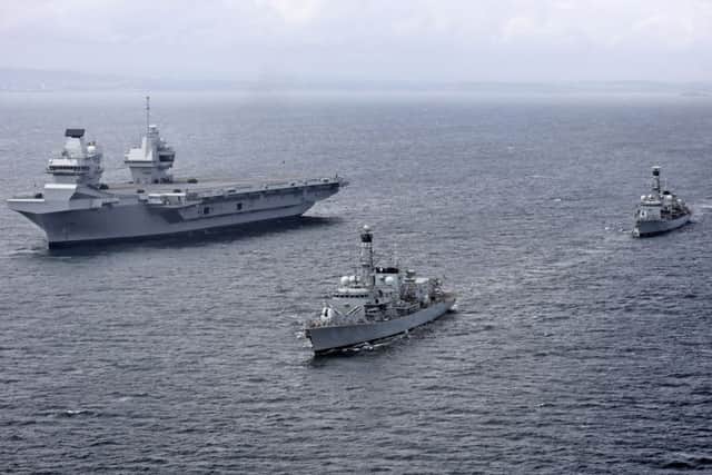 The two frigates are guarding HMS Queen Elizabeth as she tackles her sea trials PHOTO: Royal Navy