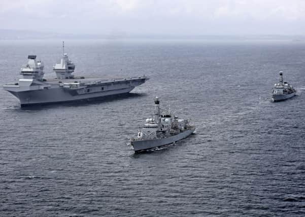 The two frigates are guarding HMS Queen Elizabeth as she tackles her sea trials PHOTO: Royal Navy