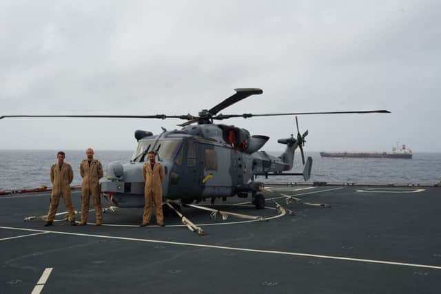 Wildcat aircrew, Winchman AET Stu Rogers, Pilot Lt Si Hall and Observer Lt Ash Morgan (flight commander) on RFA Cardigan Bay. MTM Tortola is in the background. Picture - Royal Navy, Twitter