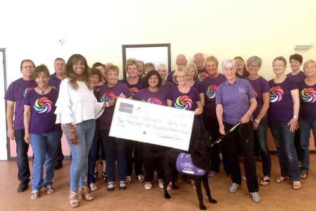 Singsational Voices with the generous Canine Partners cheque.