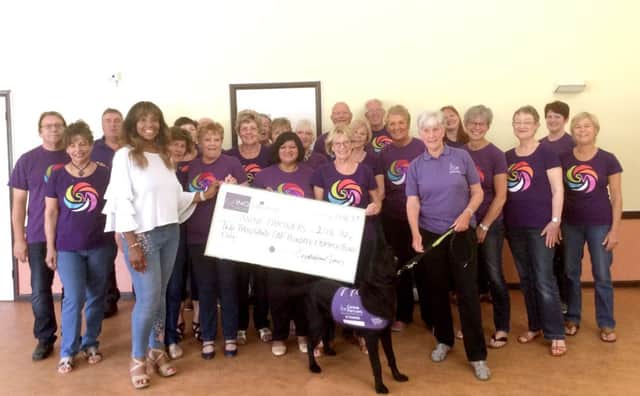 Singsational Voices with the generous Canine Partners cheque.