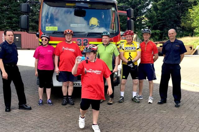 Andrew Impey, who has been given a Diana Award, with firefighters
