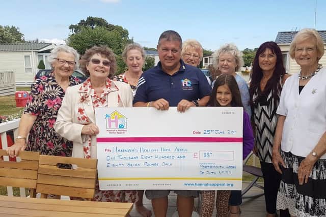 Members from Portsmouth Lodge of Duty No77 of the Order of Women Freemasons present a cheque to volunteers from Hannahs Holiday Home