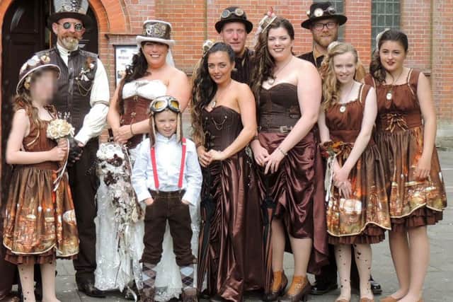 Mike & Peta Yates, top left, with their children and foster children outside Holy Trinity Church, Gosport