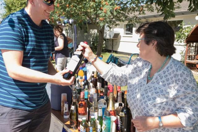 Declan Hellyer is presented with his prize from the bottle stall